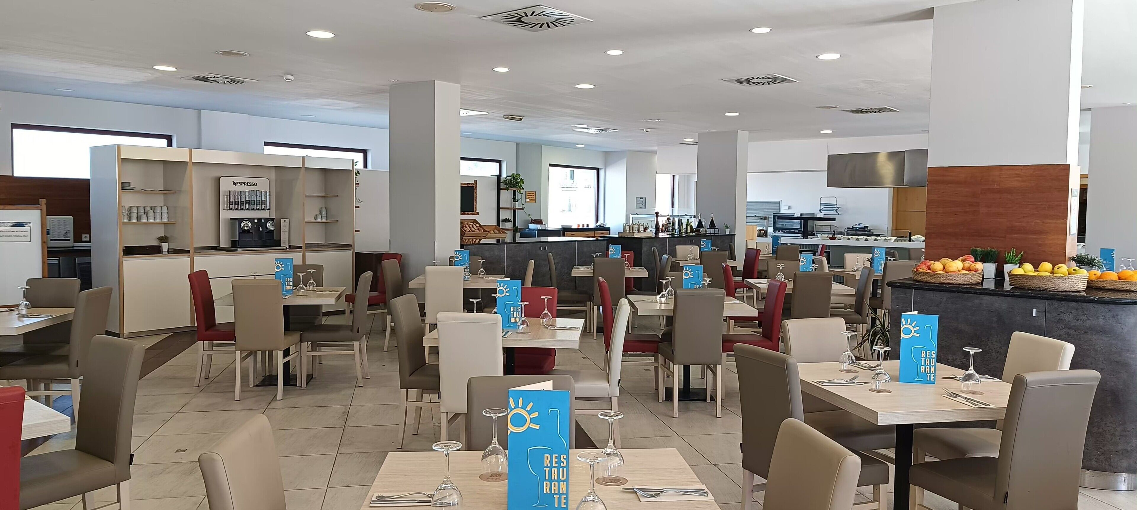 A modern restaurant with multiple dining areas, a bar, and a coffee station.