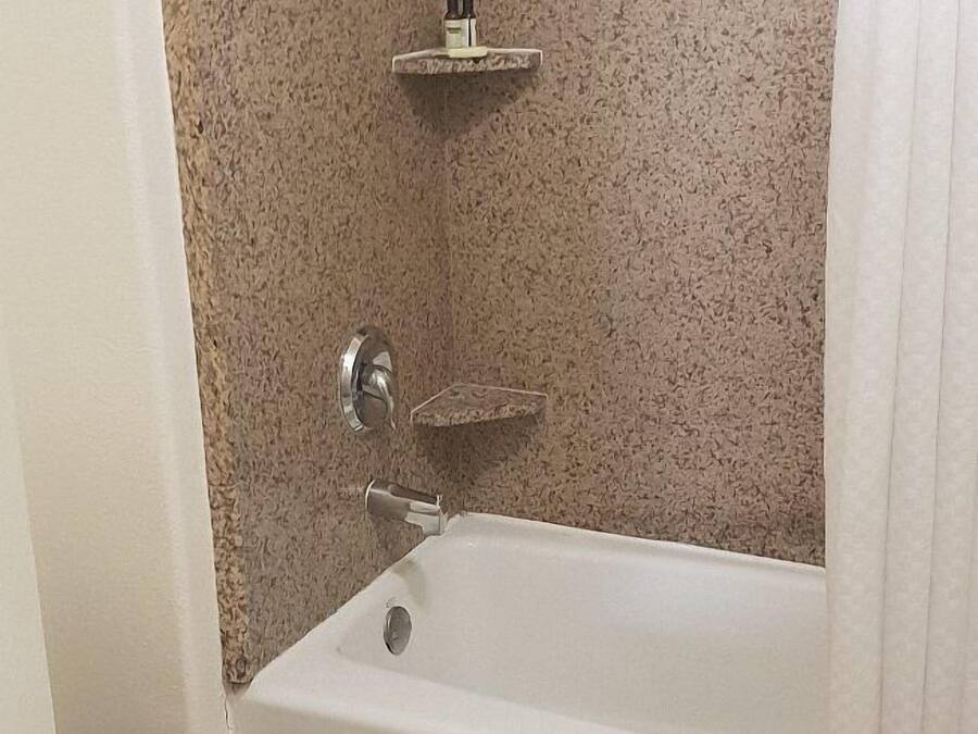 A bathroom with a bathtub, a toilet, and a shower.