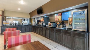 A modern breakfast area with a counter, seating, and a refrigerator.