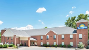 A Days Inn with a brick facade, a covered entrance, and a parking lot. - Days Inn by Wyndham St Peters/St Charles (St. Peters)