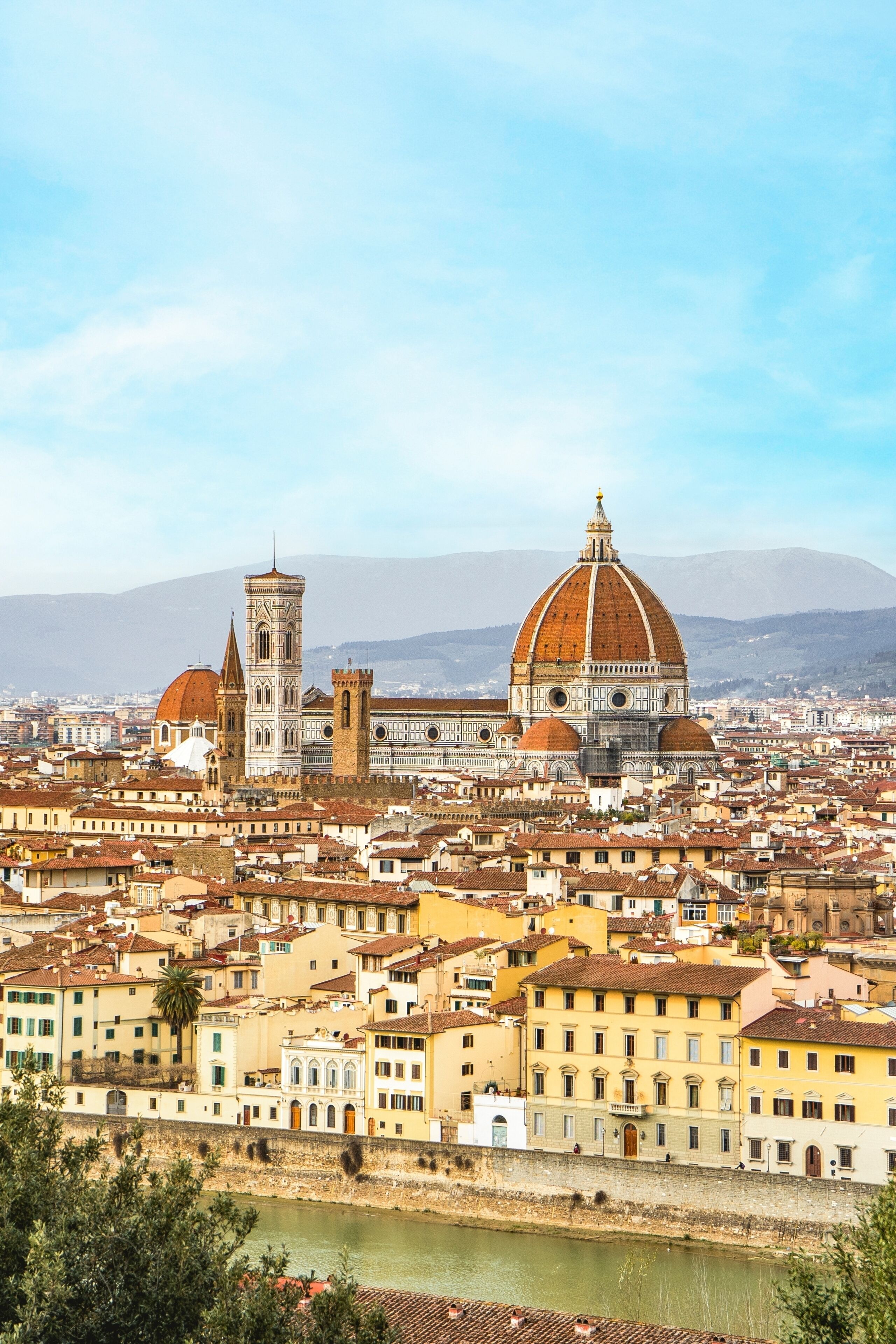 A cityscape with historic architecture, including a prominent cathedral with a large dome and a bell tower.