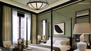 A spacious bedroom with a four-poster bed, a large mirror, and a modern chandelier.