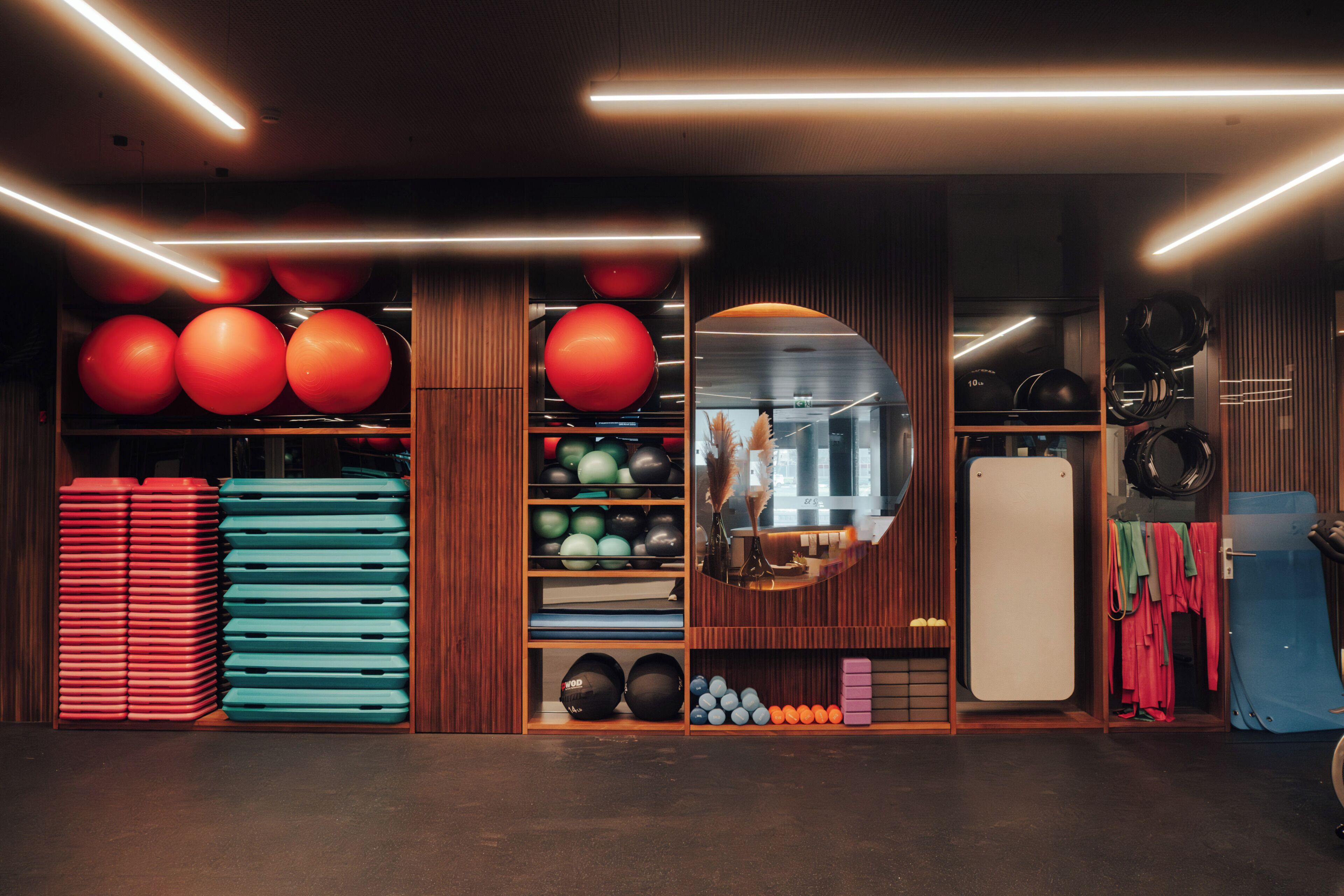 A gym with exercise equipment, a mirror, and a whiteboard.
