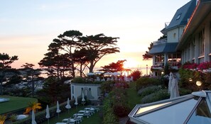 A resort with a pool, sun loungers, and a large tree in the foreground. - TI AL LANNEC Hotel - Restaurant & Spa (Trébeurden)
