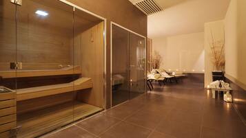 A modern spa area with a wooden bench, glass doors, and a seating area with chairs and a table.