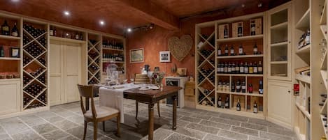 A wine cellar with wooden shelves and a heart-shaped decoration on the wall.
