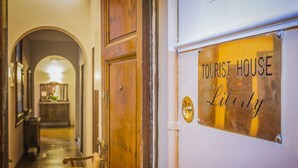 A hallway leading to a door labeled "TOURIST HOUSE Liberty." - Tourist House Liberty (Florence)