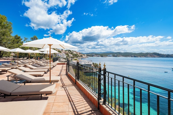 Outdoor pool, a rooftop pool, pool umbrellas, sun loungers