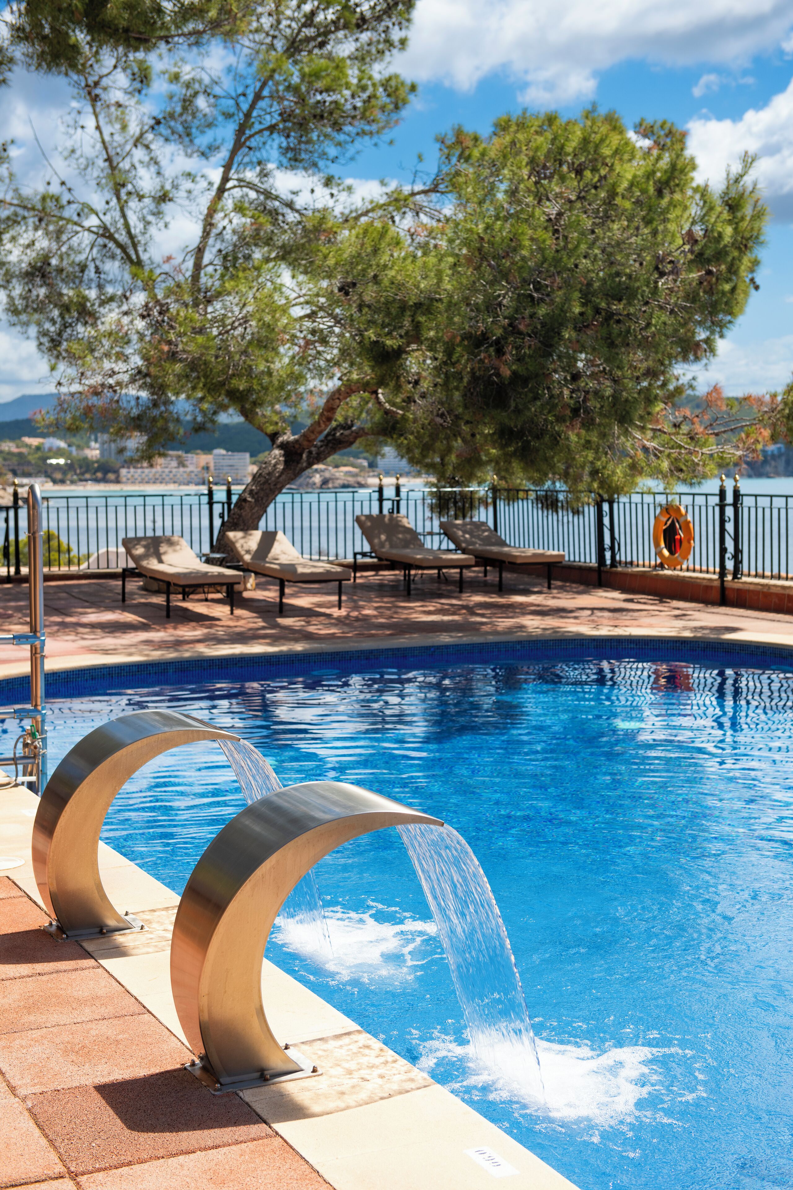 Outdoor pool, a rooftop pool, pool umbrellas, sun loungers