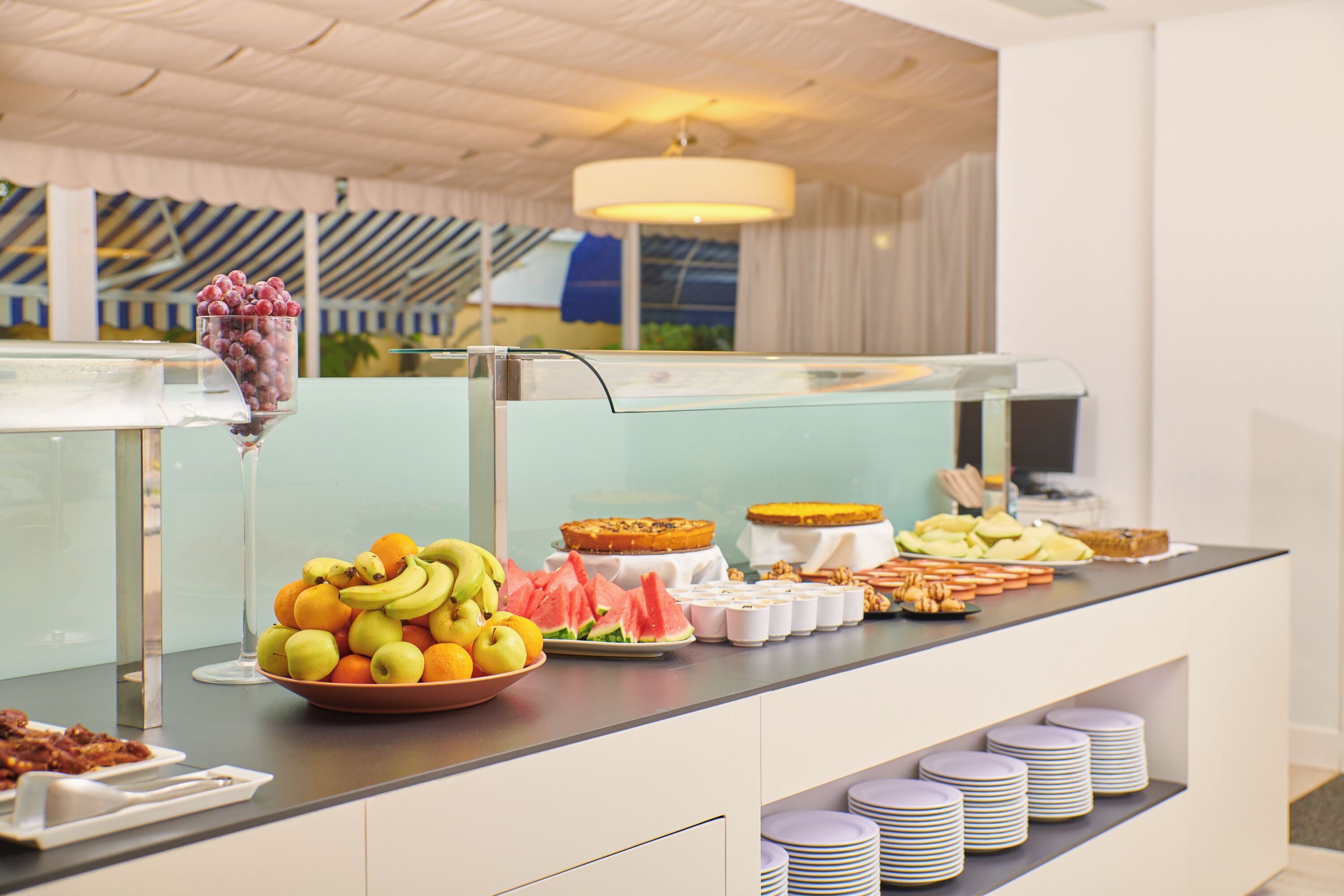 A buffet with fruits, pastries, and a variety of breakfast items.