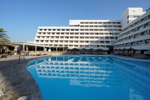A hotel with a large swimming pool, multiple balconies, and lounge areas. - Alua Golf Trinidad (Roquetas de Mar)