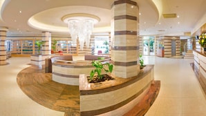 A spacious lobby with a central fountain, marble columns, and a seating area. - ALEGRIA Florida Park (Santa Susanna)