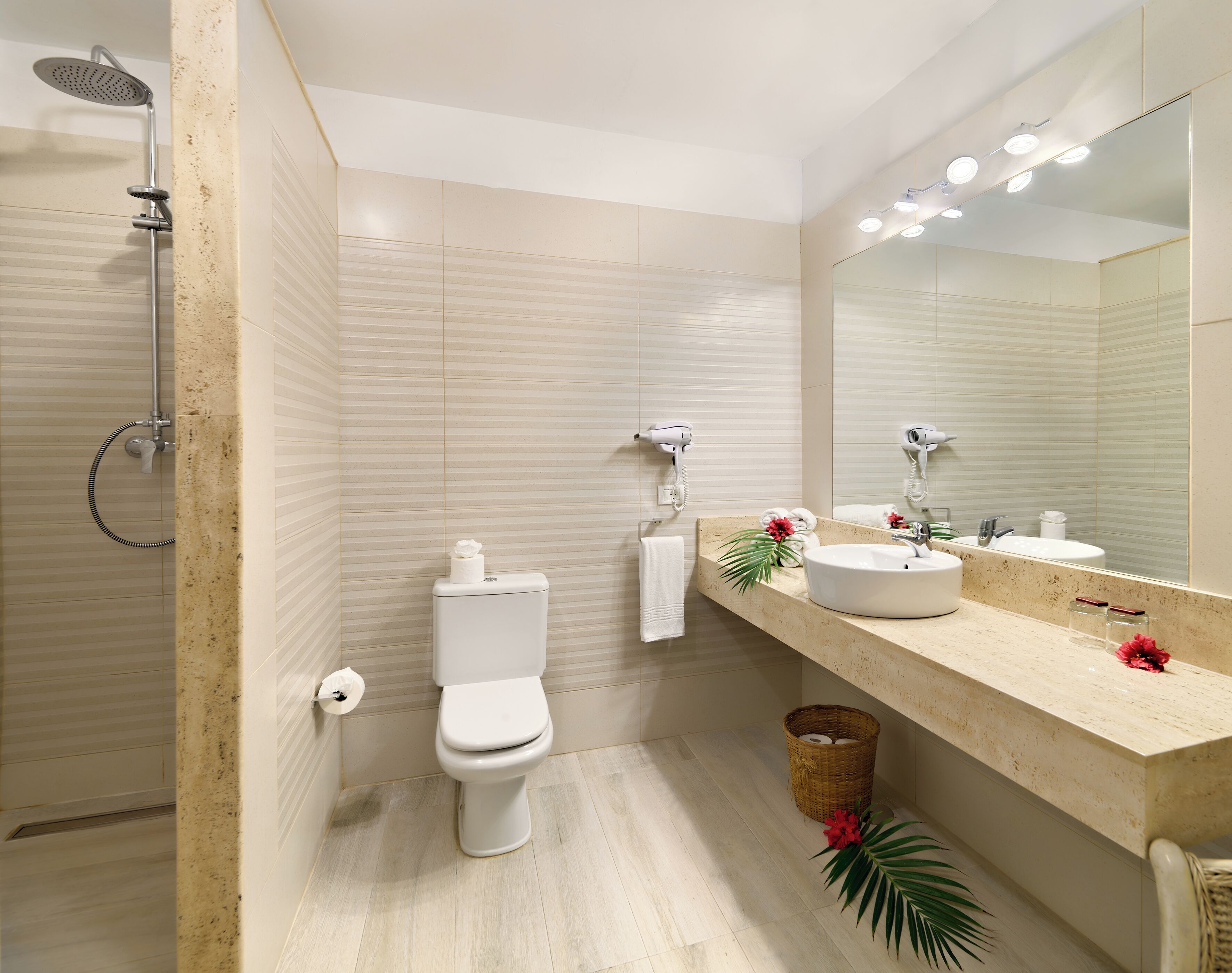 A modern bathroom with a toilet, bidet, and shower.