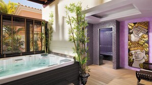 A spa area with a hot tub, bamboo plants, and a Buddha statue. - GREEN GARDEN ECO RESORT & VILLAS (Arona)