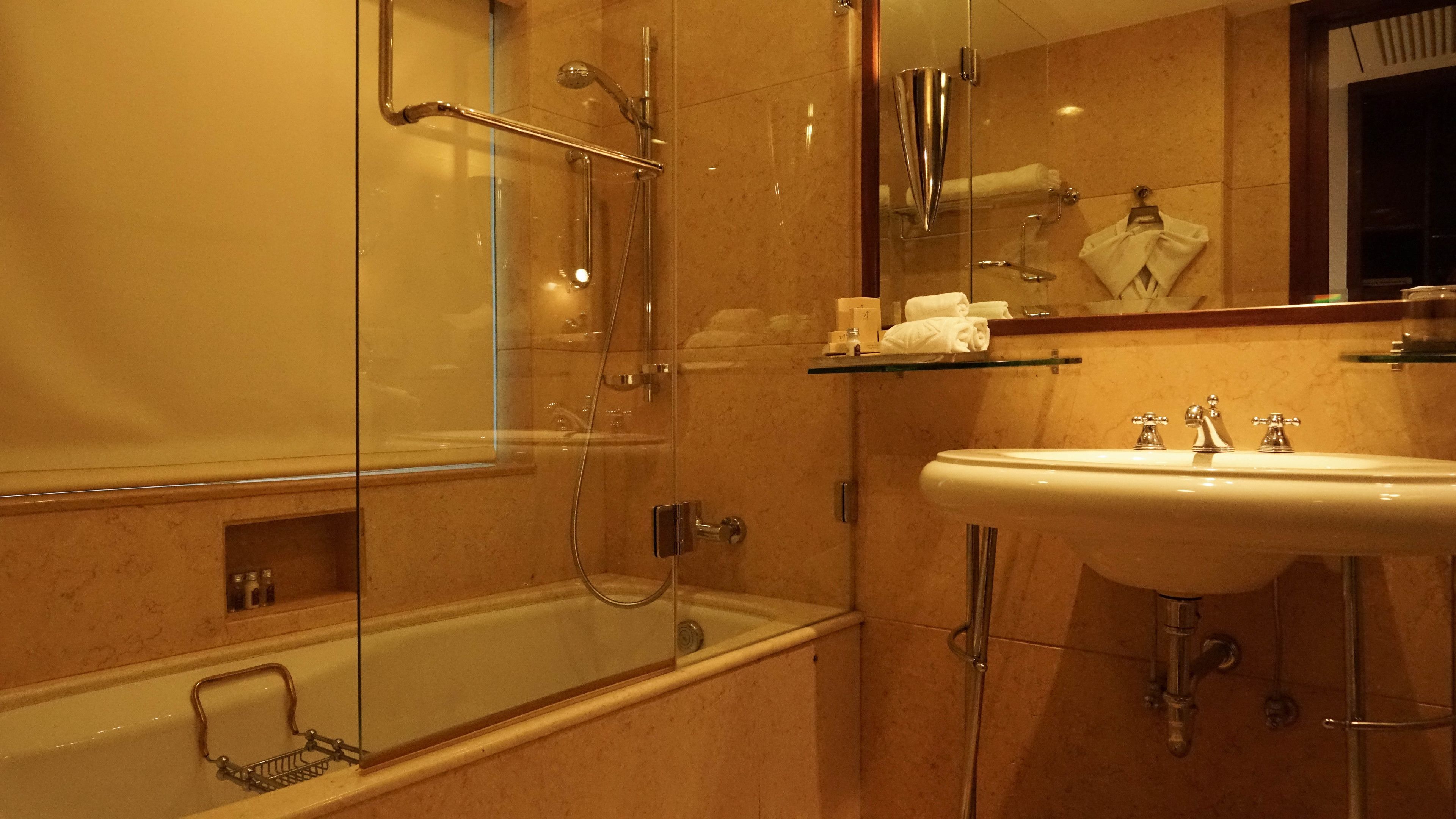 luxury suite, 1 king bed | bathroom | hair dryer, slippers, towels