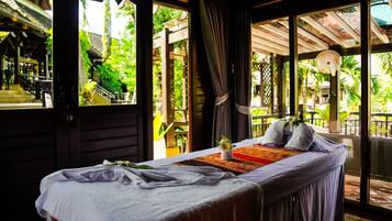 Relax in a serene guest room with a large bed, lush views, and elegant touches.