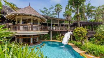 A resort with a pool, a gazebo, and a slide.
