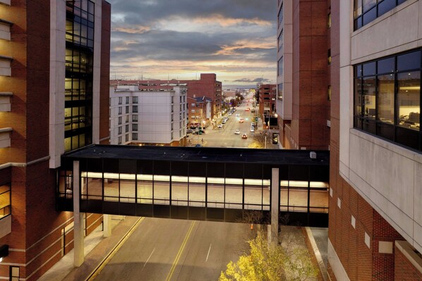 A multi-story building with large windows and a covered walkway.