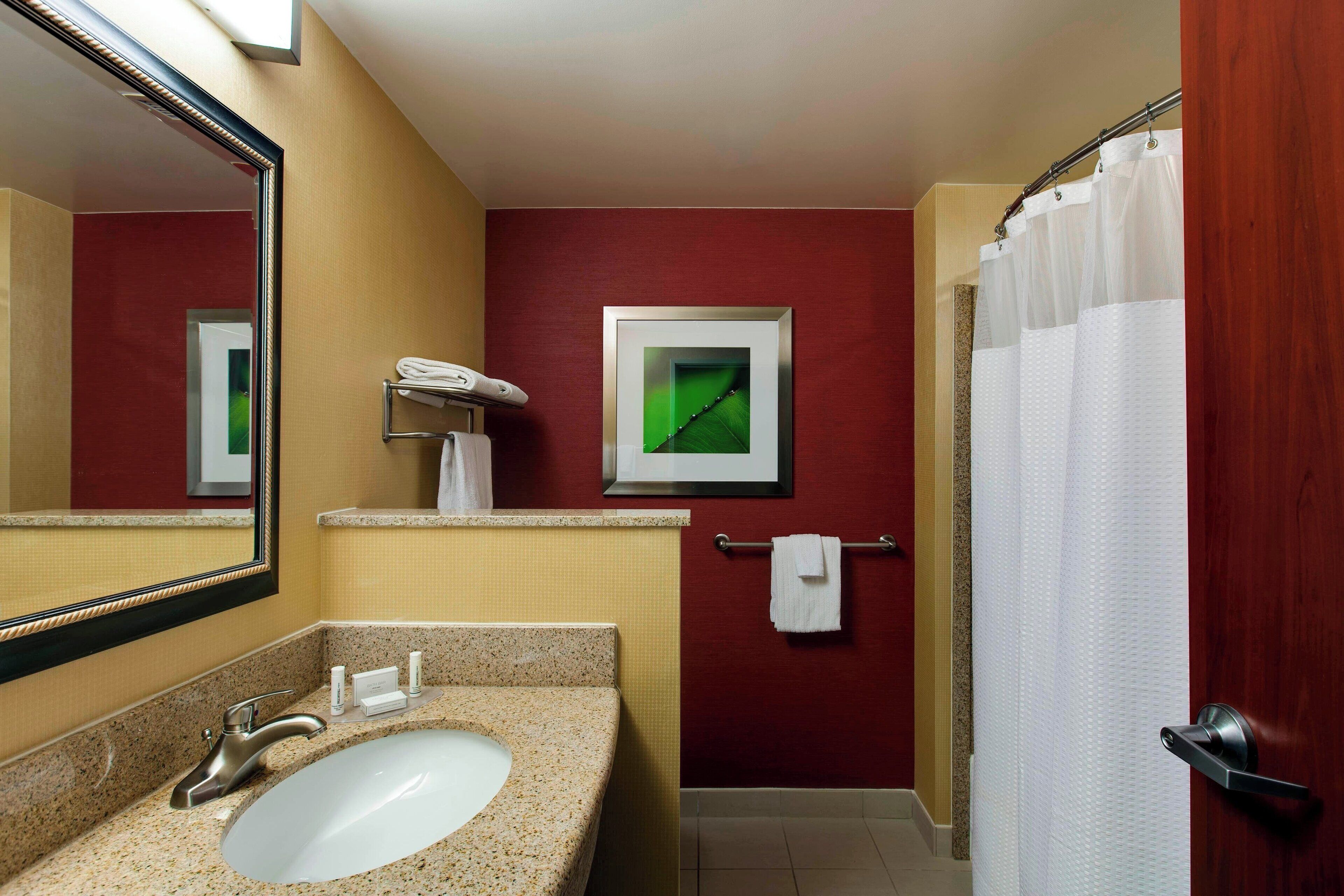 combined shower/bathtub, designer toiletries, hair dryer, towels