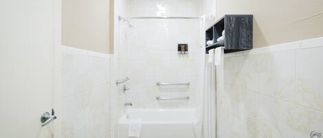 A bathroom with a bathtub, a shower, and a toilet.