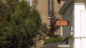 Un hotel a orillas del río, con un cartel que indica que es hotel y restaurante.