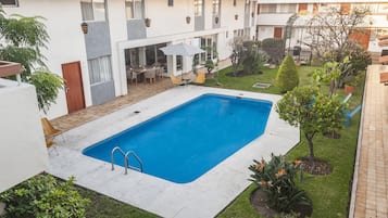 Outdoor pool, open 9:00 AM to 9:00 PM, pool umbrellas, pool loungers