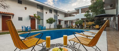 Outdoor pool, open 9:00 AM to 9:00 PM, pool umbrellas, pool loungers