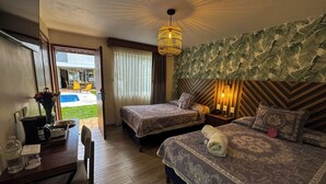 A hotel room with two beds, a desk, and a chair. There is a view of a pool outside. - Hotel Isabel (Guadalajara)