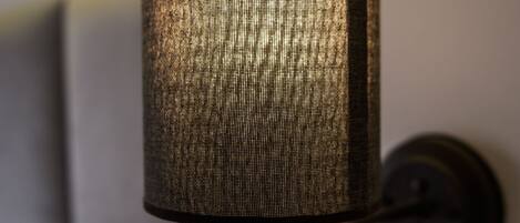 A wall-mounted lamp with a textured cylindrical shade.