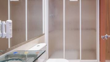 Une salle de bain moderne avec une douche à parois de verre, un lavabo en verre et des toilettes.