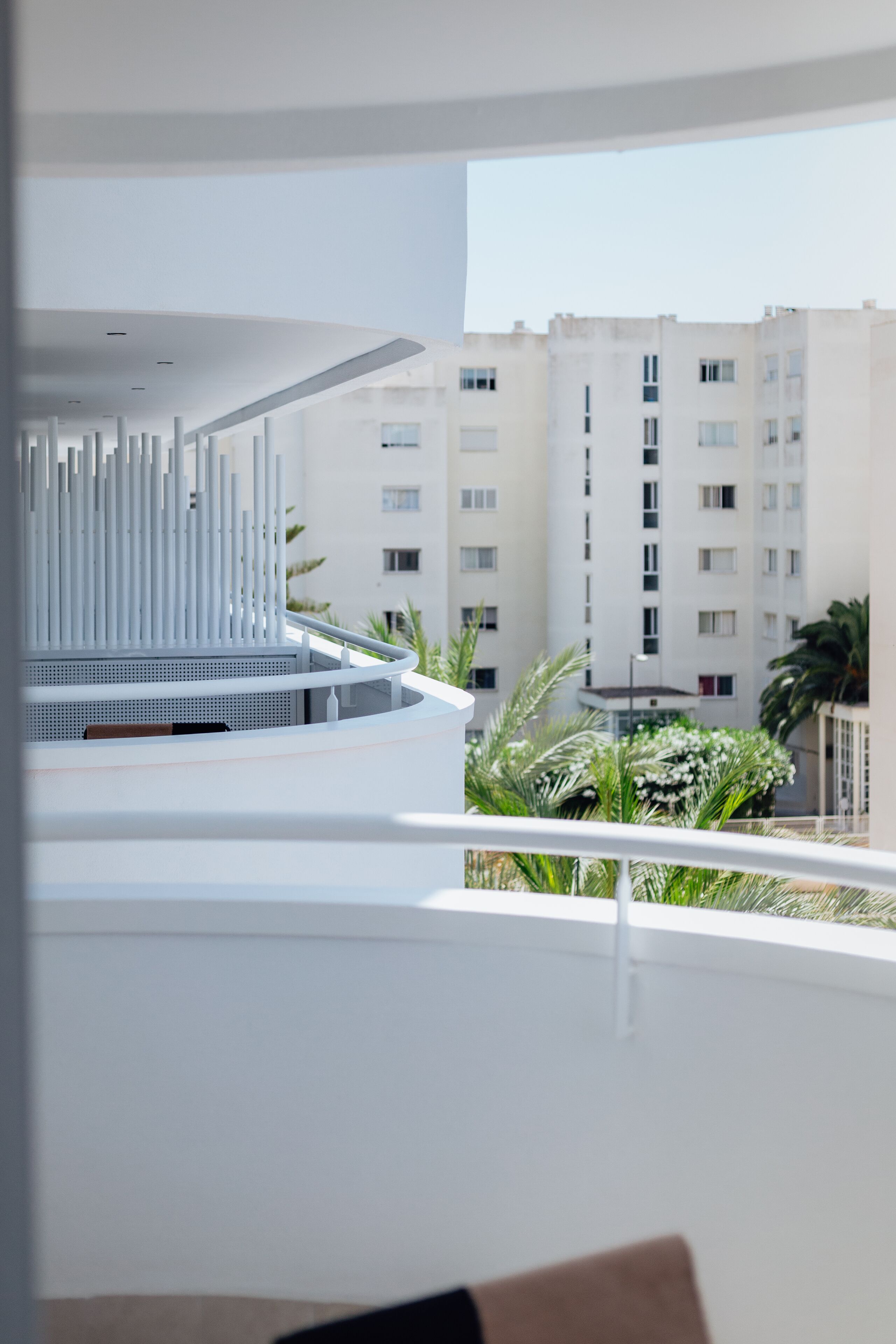 Un interior moderno con techo blanco y balcón con vistas a una zona residencial.