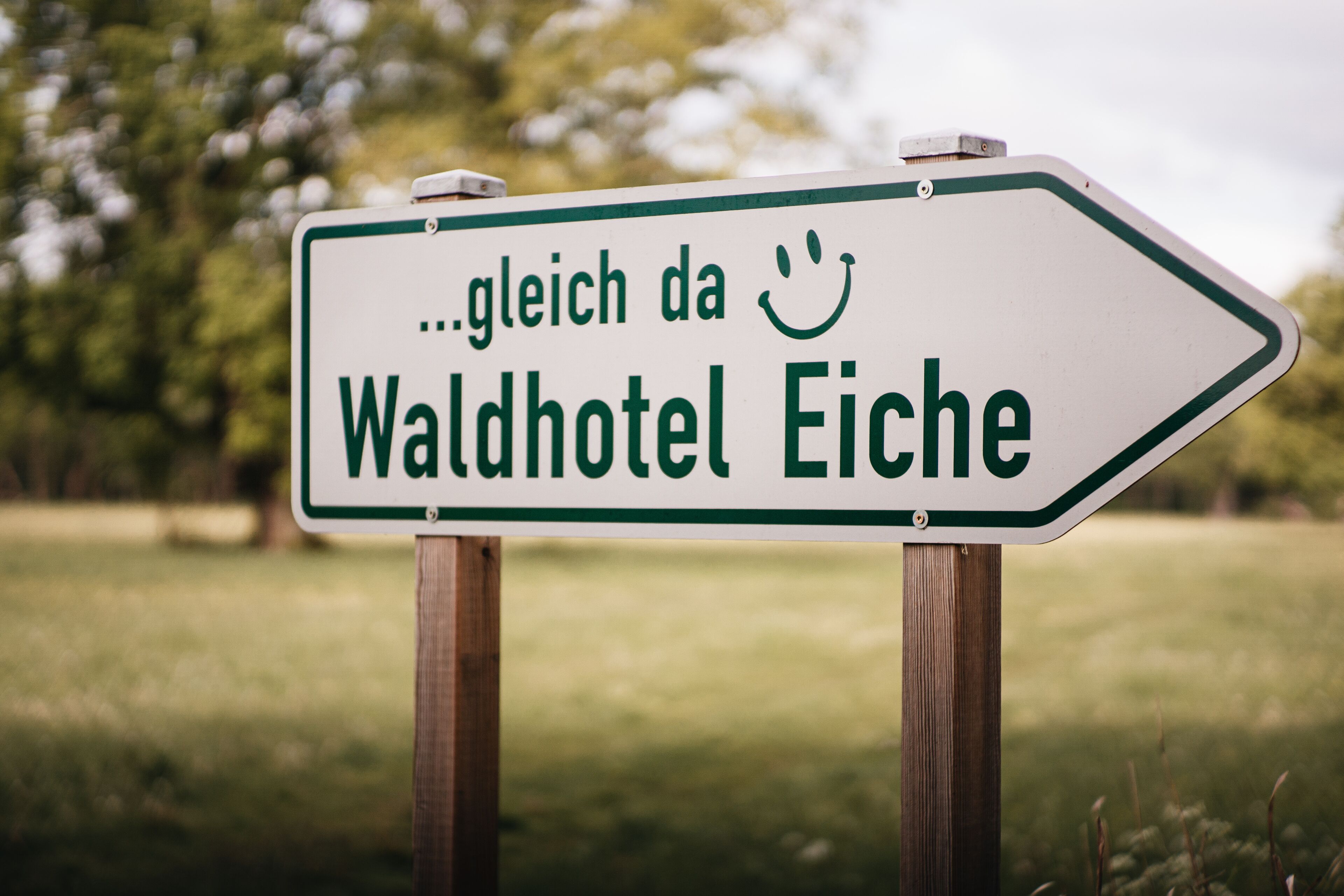 A directional sign for Waldhotel Eiche.