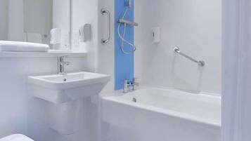 A modern bathroom with a white sink, a toilet, and a bathtub.