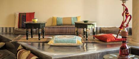 A living room with a sofa, coffee table, and decorative items.