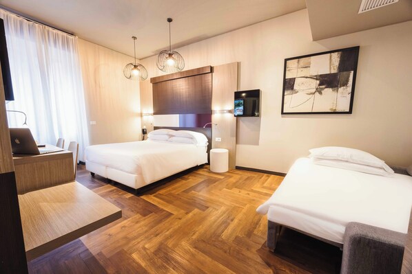 Triple Room | Minibar, in-room safe, desk, iron/ironing board