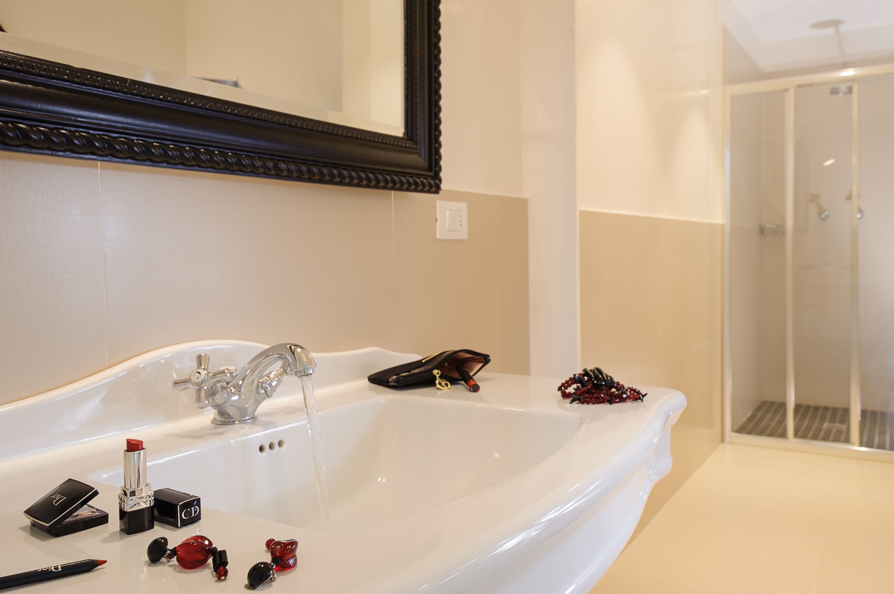 A bathroom with a large white bathtub, a mirror, and a shower area.