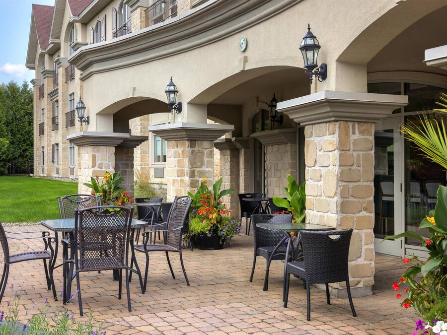 A patio area with outdoor furniture and potted plants.