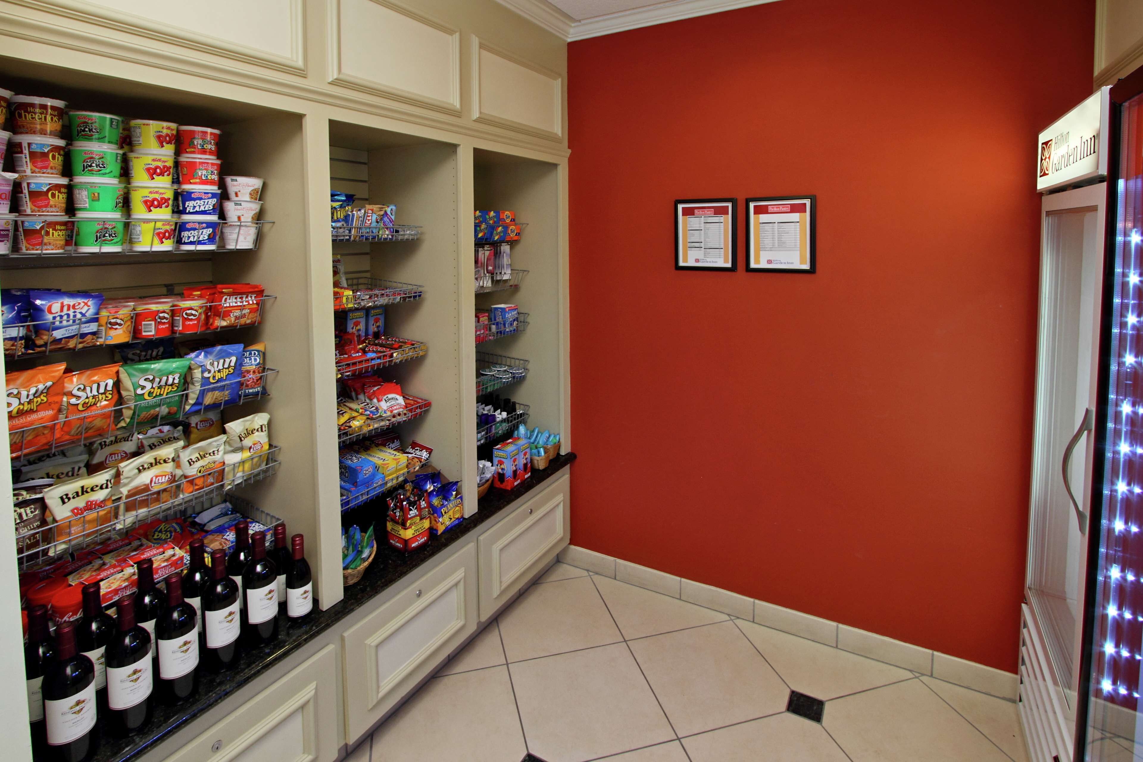 A kitchen with shelves stocked with snacks, beverages, and baking supplies.