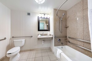 A modern bathroom with a toilet, sink, and bathtub. - Hilton Garden Inn Oxnard/Camarillo (Oxnard)