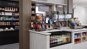 A store with shelves stocked with snacks, beverages, and specialty coffee. - Hilton Garden Inn Indianapolis Northeast/Fishers (Fishers)