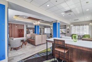 A modern interior with a seating area, a kitchen, and a dining space.
