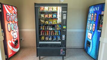 A vending machine with a variety of snacks and drinks, including Haribo Gold-Bears and Coca-Cola.