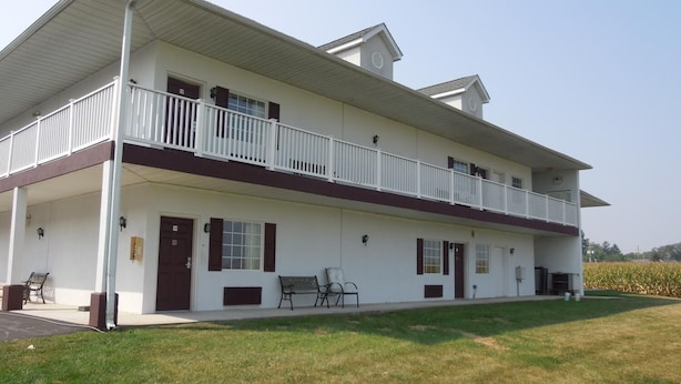 A two-story building with a covered porch and a balcony on the upper floor. - Scottish Inn Ronks (Ronks)