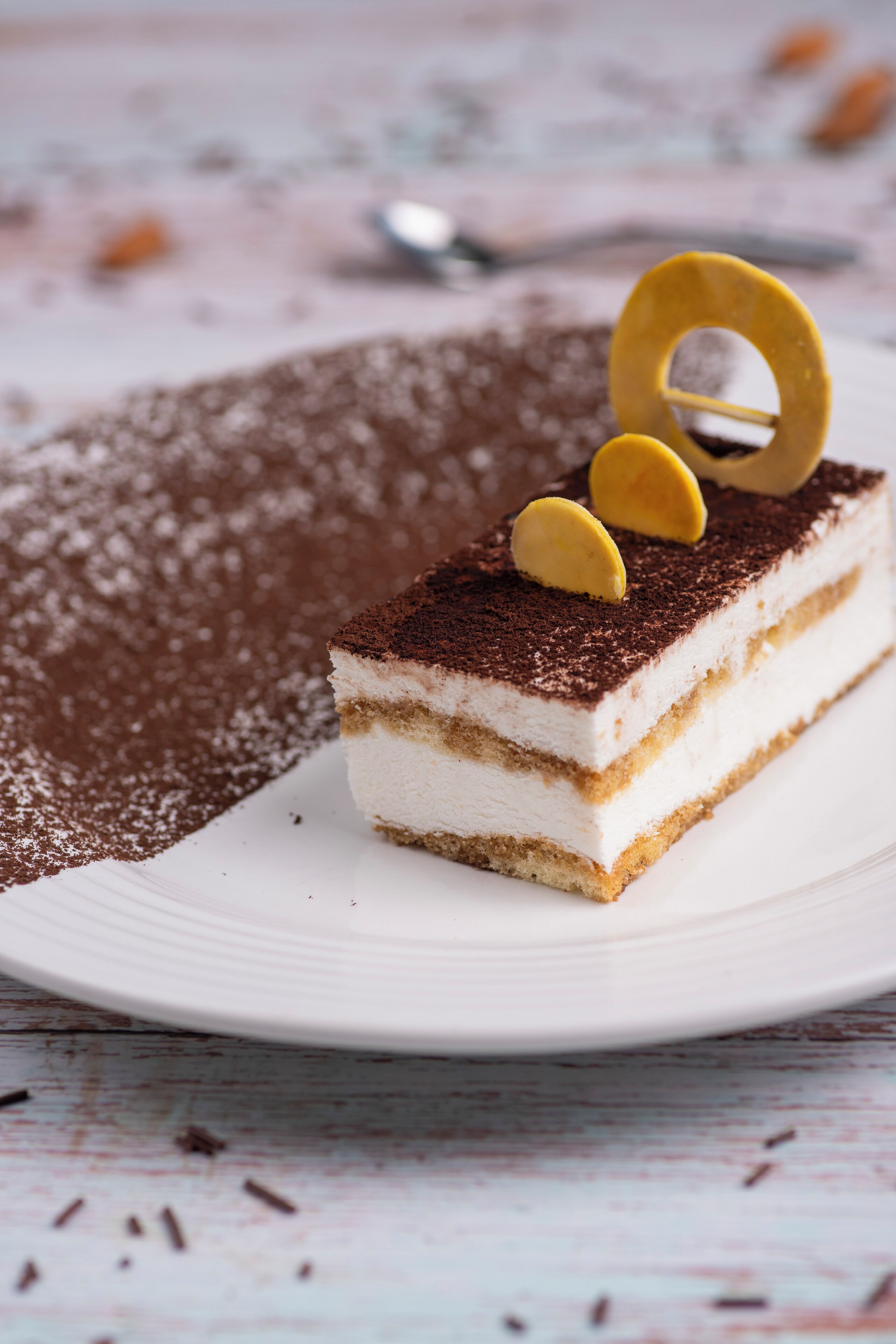 A slice of layered dessert on a white plate.