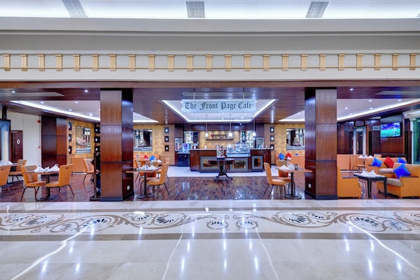A hotel lobby with a reception desk, seating areas, and a coffee bar. - Pearl Continental Rawalpindi (Rawalpindi)