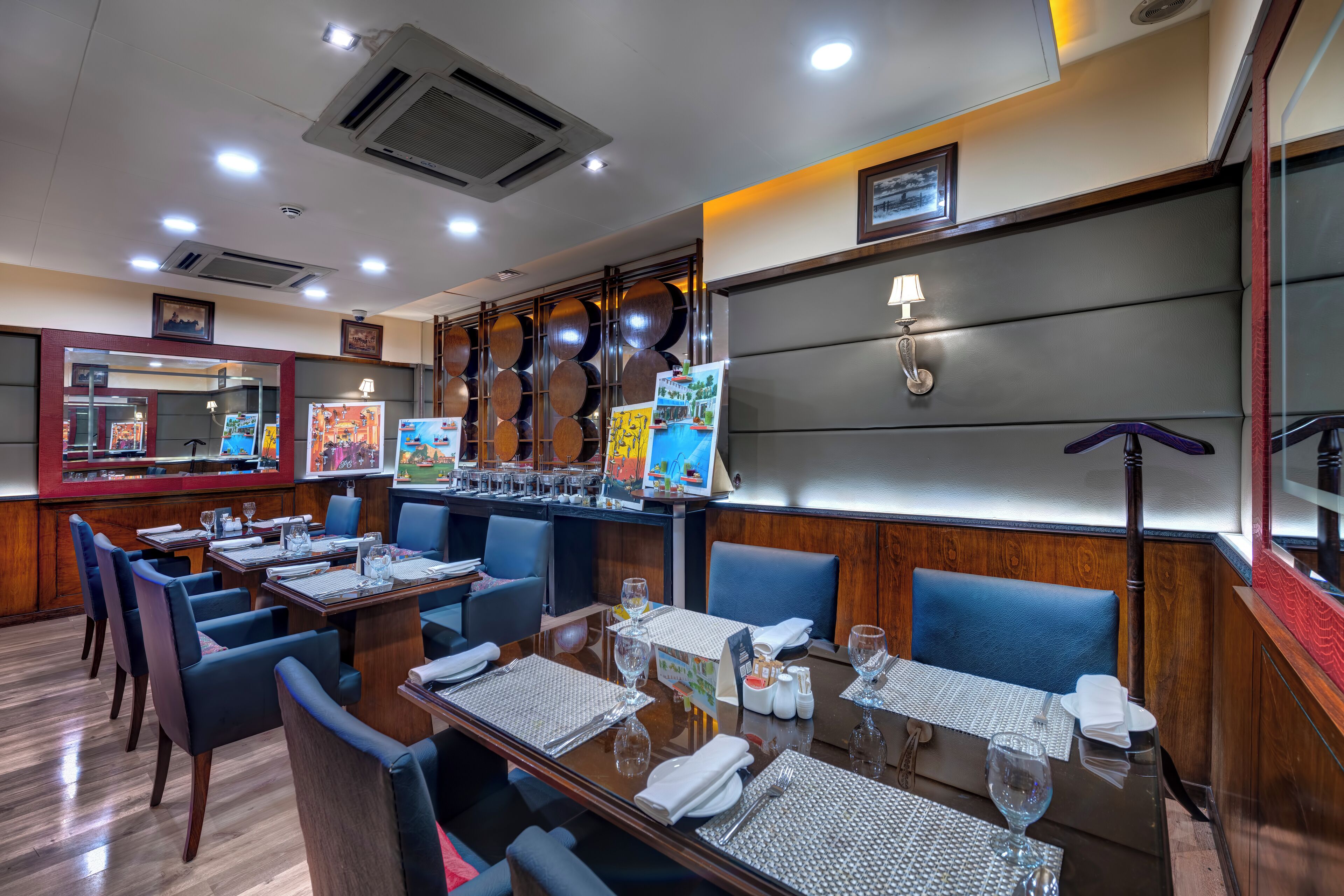 A restaurant with multiple tables, chairs, and a bar area.