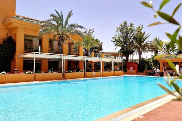 2 indoor pools, 2 outdoor pools, open 8 AM to 7 PM, pool umbrellas