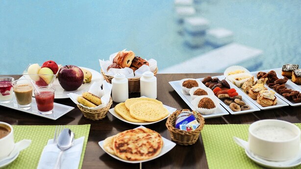 A breakfast buffet with various pastries, fruits, and beverages. - Hotel ibis El Jadida (El Jadida)