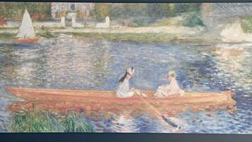 A serene riverside scene with a rowboat and two figures.