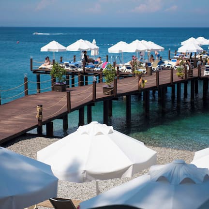 On the beach, black sand, sun loungers, beach umbrellas